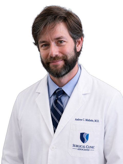 Portrait of Drew Mallette, MD, FACS, in a white coat